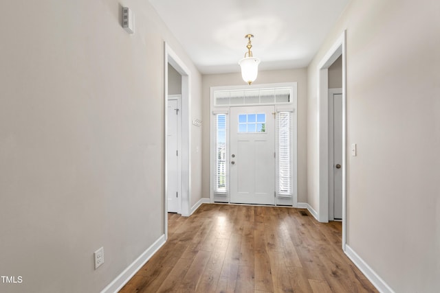 24 Windchime Ct, Clayton, NC 27527 - foyer featuring hardwood / wood-style flooring and baseboards