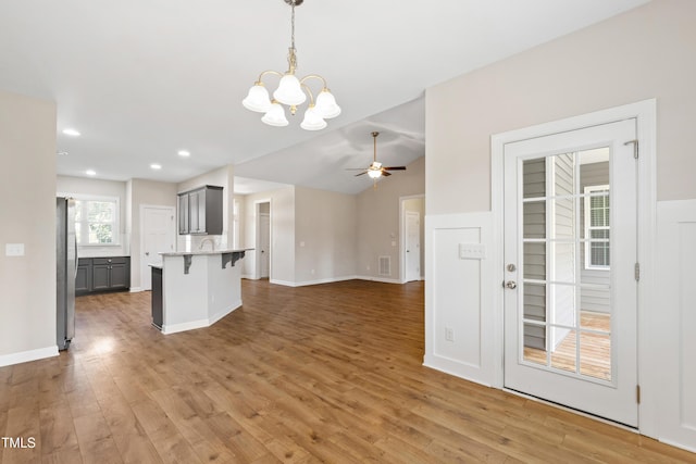 24 Windchime Ct, Clayton, NC 27527 - kitchen with freestanding refrigerator, gray cabinets, a kitchen breakfast bar, a chandelier, and ceiling fan