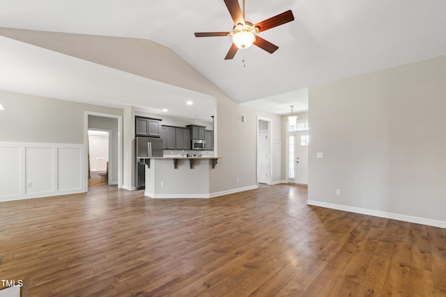 24 Windchime Ct, Clayton, NC 27527 - unfurnished living room featuring a ceiling fan, vaulted ceiling, and wood finished floors