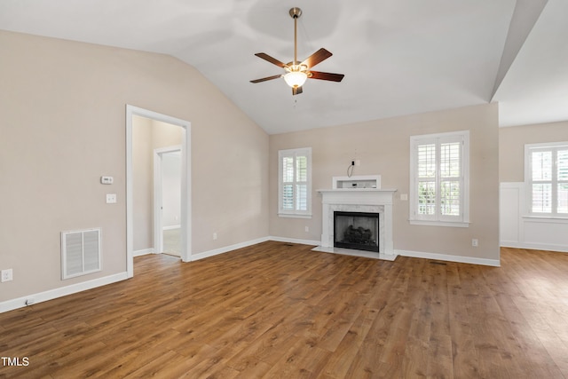 24 Windchime Ct, Clayton, NC 27527 - unfurnished living room with vaulted ceiling, a ceiling fan, wood finished floors, and a high end fireplace