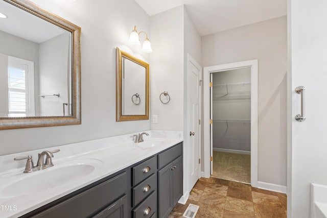 24 Windchime Ct, Clayton, NC 27527 - bathroom featuring double vanity and a spacious closet