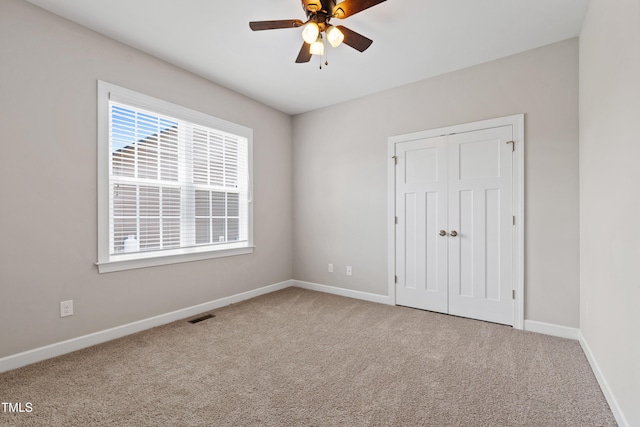 24 Windchime Ct, Clayton, NC 27527 - unfurnished bedroom with carpet floors, a closet, and a ceiling fan