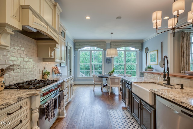 633 Rolling Springs Dr, Cary, NC 27519 - kitchen with stainless steel appliances, cream cabinetry, healthy amount of natural light, ornamental molding, and backsplash