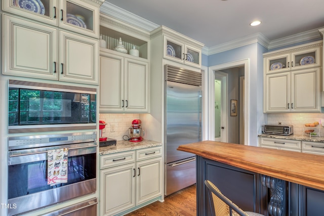 633 Rolling Springs Dr, Cary, NC 27519 - kitchen with built in appliances, butcher block countertops, tasteful backsplash, a warming drawer, and ornamental molding