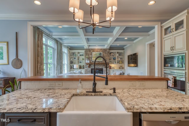 633 Rolling Springs Dr, Cary, NC 27519 - kitchen featuring oven, built in microwave, open floor plan, dishwasher, and a chandelier