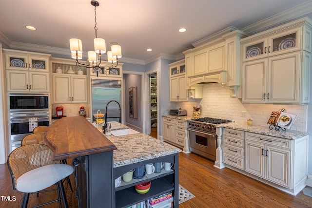 633 Rolling Springs Dr, Cary, NC 27519 - kitchen with built in appliances, open shelves, a chandelier, backsplash, and an island with sink