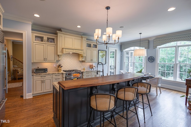 633 Rolling Springs Dr, Cary, NC 27519 - kitchen with butcher block countertops, high end stove, a chandelier, crown molding, and backsplash