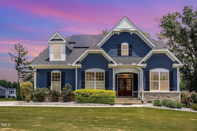 119 Florentino Ct, Clayton, NC 27527 - view of front of property with french doors, a front lawn, roof mounted solar panels, and a shingled roof
