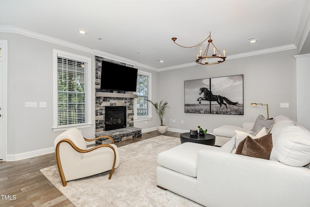 119 Florentino Ct, Clayton, NC 27527 - living area with wood finished floors, a chandelier, crown molding, a fireplace, and recessed lighting