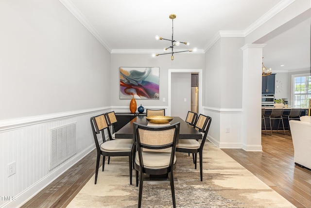 119 Florentino Ct, Clayton, NC 27527 - dining area featuring a chandelier, wood-type flooring, and crown molding