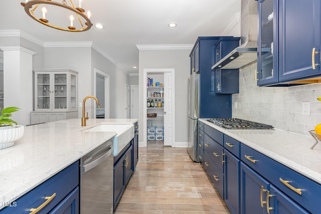119 Florentino Ct, Clayton, NC 27527 - kitchen featuring stainless steel appliances, blue cabinetry, wall chimney range hood, light wood-style floors, and recessed lighting