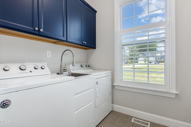 119 Florentino Ct, Clayton, NC 27527 - laundry area with separate washer and dryer, cabinet space, and light tile patterned floors