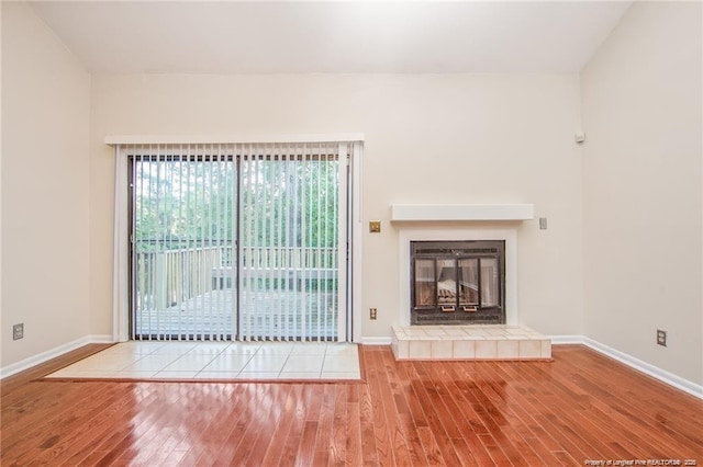 400 Cypress Trace Dr, Fayetteville, NC 28314 - unfurnished living room with wood finished floors and a tile fireplace