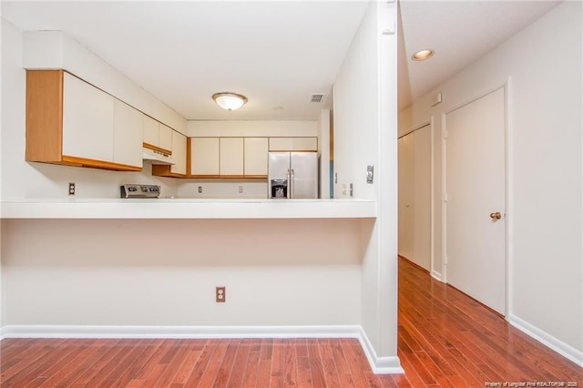 400 Cypress Trace Dr, Fayetteville, NC 28314 - kitchen with stainless steel refrigerator with ice dispenser, a peninsula, under cabinet range hood, and wood finished floors