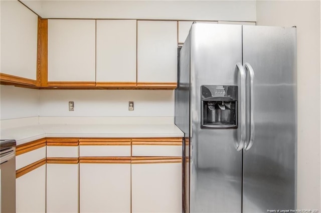 400 Cypress Trace Dr, Fayetteville, NC 28314 - kitchen with stainless steel fridge with ice dispenser, light countertops, and white cabinetry