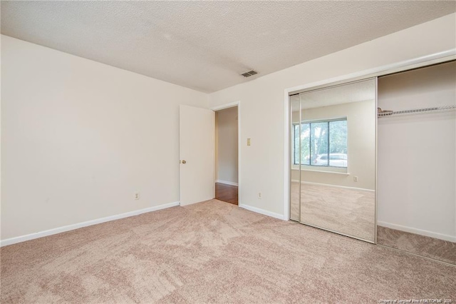 400 Cypress Trace Dr, Fayetteville, NC 28314 - unfurnished bedroom with carpet floors, a closet, and a textured ceiling