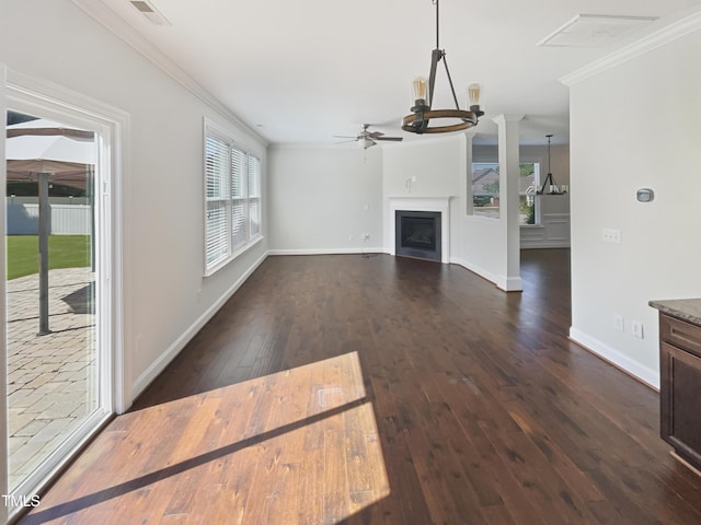 1092 Adams Point Dr, Garner, NC 27529 - unfurnished living room with ceiling fan, ornamental molding, dark wood-type flooring, a fireplace, and a chandelier