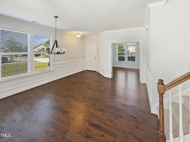 1092 Adams Point Dr, Garner, NC 27529 - unfurnished dining area with crown molding, a chandelier, dark wood-style flooring, wainscoting, and stairs