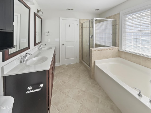 1092 Adams Point Dr, Garner, NC 27529 - full bath with double vanity, a garden tub, tile patterned floors, and a shower stall