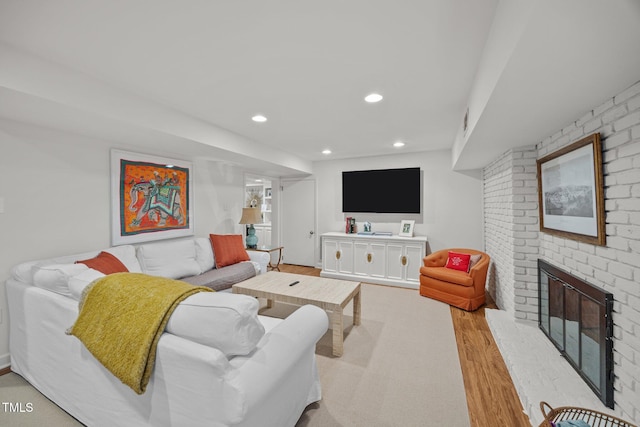 227 W Drewry Ln, Raleigh, NC 27609 - living room featuring wood finished floors, recessed lighting, and a brick fireplace