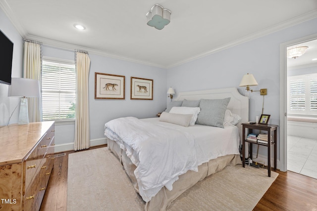 227 W Drewry Ln, Raleigh, NC 27609 - bedroom with multiple windows, crown molding, and wood finished floors