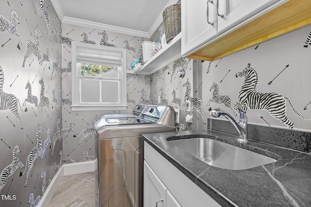 227 W Drewry Ln, Raleigh, NC 27609 - laundry area with wallpapered walls, ornamental molding, washer and dryer, and cabinet space