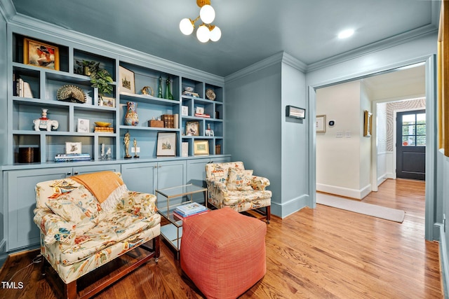 227 W Drewry Ln, Raleigh, NC 27609 - sitting room featuring ornamental molding, light wood-style floors, and a chandelier