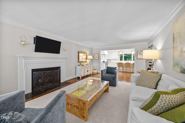 227 W Drewry Ln, Raleigh, NC 27609 - living room featuring ornamental molding, light wood-style floors, and a fireplace with flush hearth