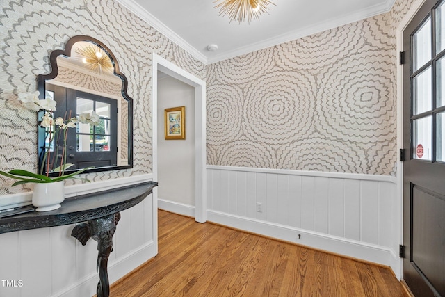 227 W Drewry Ln, Raleigh, NC 27609 - foyer entrance with wallpapered walls, ornamental molding, wainscoting, and wood finished floors