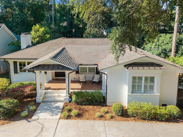227 W Drewry Ln, Raleigh, NC 27609 - view of front of home with brick siding, a shingled roof, and a chimney