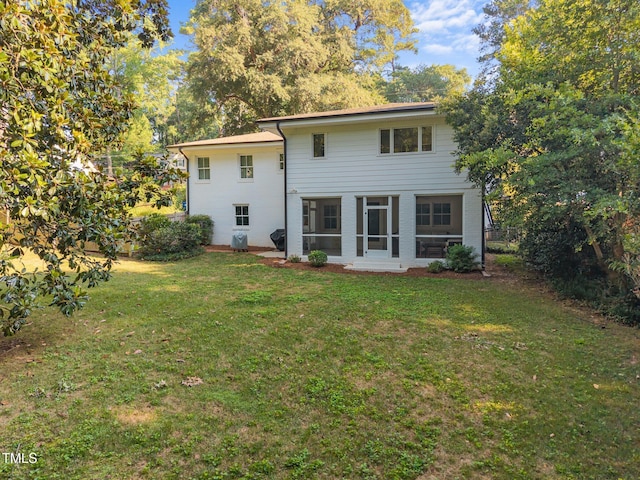 227 W Drewry Ln, Raleigh, NC 27609 - rear view of house featuring a lawn and a sunroom