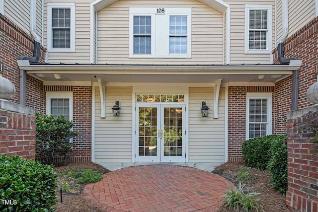 108-203 Northbrook Dr Unit 203, Raleigh, NC 27609 - view of exterior entry with french doors and brick siding