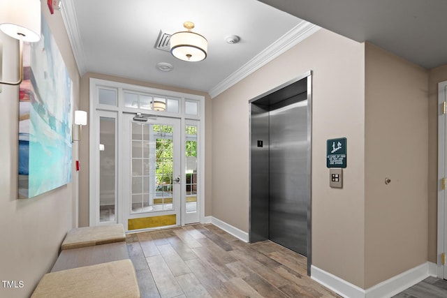 108-203 Northbrook Dr Unit 203, Raleigh, NC 27609 - entryway featuring elevator, ornamental molding, and wood finished floors