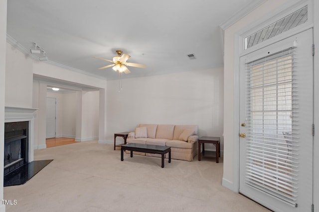 108-203 Northbrook Dr Unit 203, Raleigh, NC 27609 - living area featuring a ceiling fan, carpet, crown molding, and a fireplace