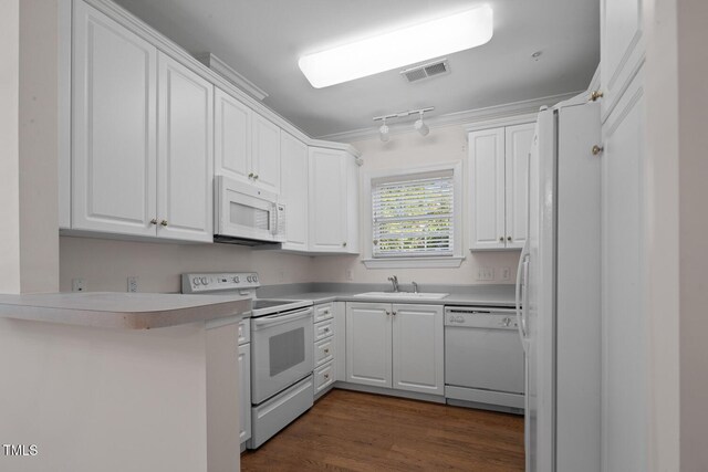 108-203 Northbrook Dr Unit 203, Raleigh, NC 27609 - kitchen featuring white appliances, white cabinetry, ornamental molding, light countertops, and dark wood-style floors