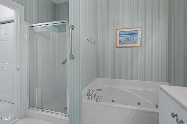 108-203 Northbrook Dr Unit 203, Raleigh, NC 27609 - bathroom with wallpapered walls, a shower stall, a jetted tub, vanity, and tile patterned flooring