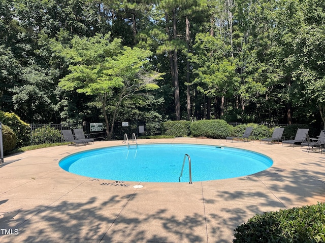 108-203 Northbrook Dr Unit 203, Raleigh, NC 27609 - community pool with a patio and view of wooded area