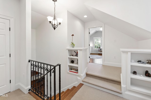 2707 Anderson Dr, Raleigh, NC 27608 - stairs featuring vaulted ceiling, carpet floors, a chandelier, and recessed lighting