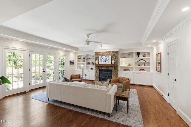 2707 Anderson Dr, Raleigh, NC 27608 - living area with ornamental molding, a ceiling fan, wood finished floors, a fireplace, and french doors