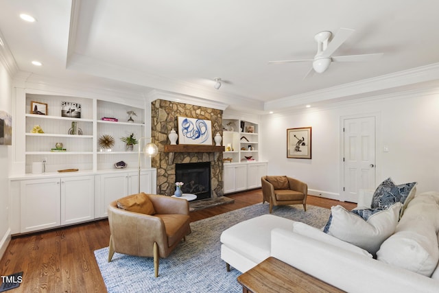 2707 Anderson Dr, Raleigh, NC 27608 - living room with crown molding, a ceiling fan, dark wood-style floors, a stone fireplace, and recessed lighting