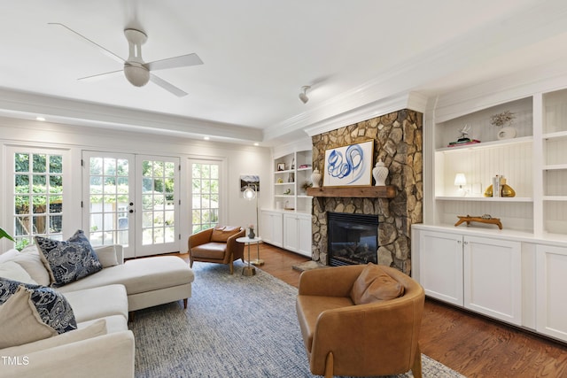 2707 Anderson Dr, Raleigh, NC 27608 - living area featuring ornamental molding, dark wood-style floors, a ceiling fan, a fireplace, and french doors