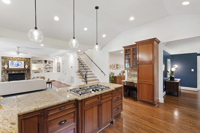 2707 Anderson Dr, Raleigh, NC 27608 - kitchen with stainless steel gas cooktop, wood finished floors, lofted ceiling, ceiling fan, and glass insert cabinets