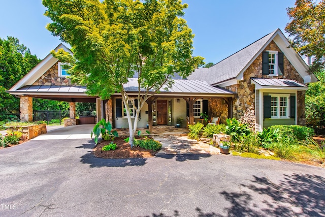 2707 Anderson Dr, Raleigh, NC 27608 - view of front facade featuring a standing seam roof, stone siding, a carport, and asphalt driveway