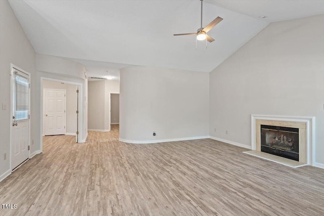 108 Ellsworth Pl, Cary, NC 27511 - unfurnished living room featuring a ceiling fan, light wood-style floors, a fireplace with raised hearth, and vaulted ceiling
