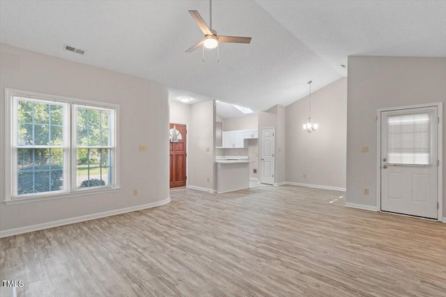 108 Ellsworth Pl, Cary, NC 27511 - unfurnished living room featuring light wood-style flooring, a ceiling fan, a chandelier, and high vaulted ceiling