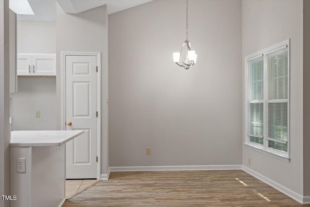 108 Ellsworth Pl, Cary, NC 27511 - unfurnished dining area featuring a chandelier and light wood-type flooring