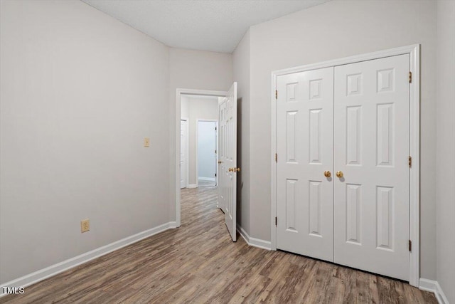 108 Ellsworth Pl, Cary, NC 27511 - unfurnished bedroom featuring wood finished floors and a closet