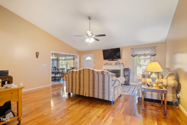 1401 Burchcrest Dr, Garner, NC 27529 - living area with a ceiling fan, light wood finished floors, lofted ceiling, and a fireplace