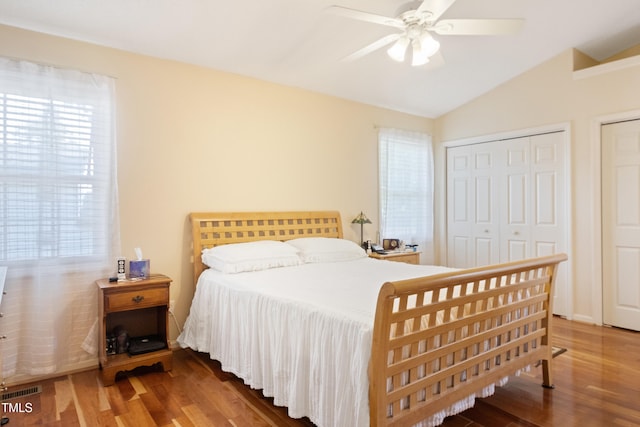 1401 Burchcrest Dr, Garner, NC 27529 - bedroom featuring wood finished floors, multiple windows, vaulted ceiling, and ceiling fan