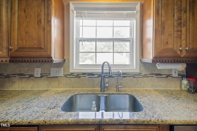 1401 Burchcrest Dr, Garner, NC 27529 - kitchen with light stone countertops, backsplash, and brown cabinetry